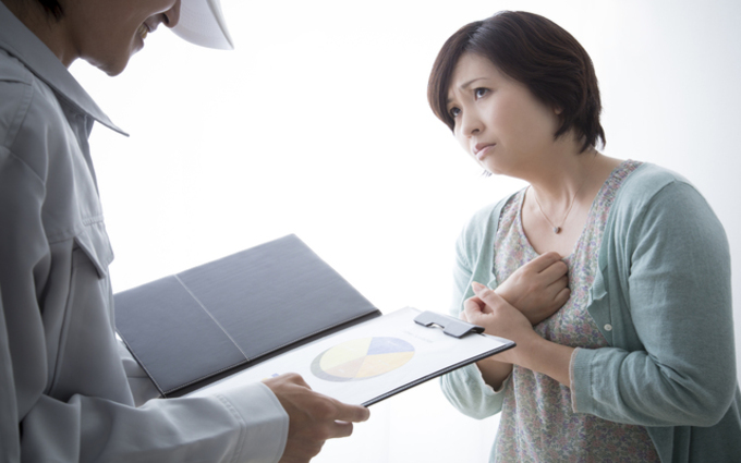 業者と業者を怪しむ女性